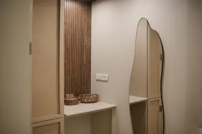a bathroom with a mirror and a surfboard on a wall at The Soul by VDN A Santorini inspired Villa in Trichūr