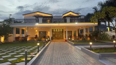 a house with a brick driveway in front of it at Kurunchi malar Resorts in Hosūr