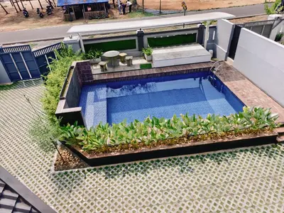 an overhead view of a swimming pool with plants at Ambadis Beach View 3BHK Pool Villa in Pallipuram