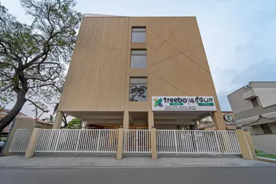 a building with a white fence in front of it at Treebo Premium Cachet Suites in Coimbatore