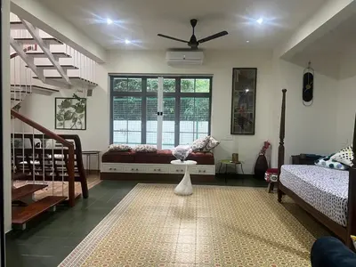 a living room with a bed and a window at Traditional house near Cochin airport in Chewarra