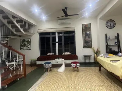 a living room with a bed and a window at Traditional house near Cochin airport in Chewarra