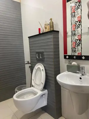 a bathroom with a toilet and a sink at Traditional house near Cochin airport in Chewarra