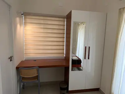 a room with a window with a desk and a chair at Balcony inn in Nedumbassery