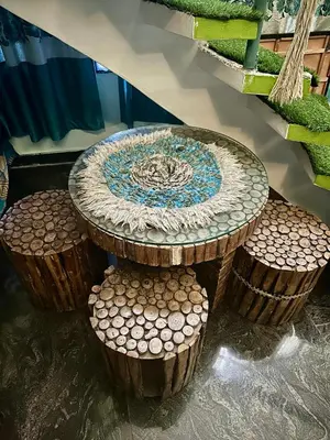 a table with four stools around it at Mysore City Center Rooms by A1k in Mysore