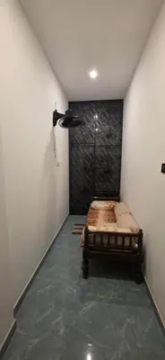 a bedroom with a bed in the corner of a room at SARA'S LUXURY stay in Coimbatore (Peelamedu)