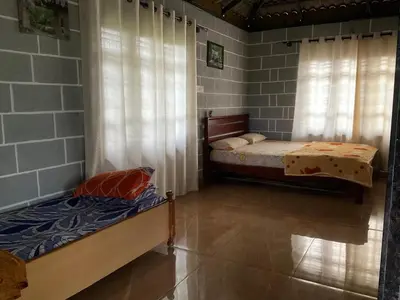 a bedroom with two beds in a room at Cozy Tiny Farm Stay in Mysore