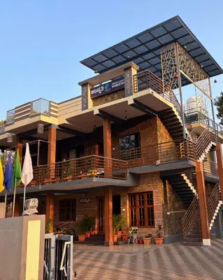 a building with a balcony and stairs on it at Unnati Luxury Homestay Coorg in Madikeri
