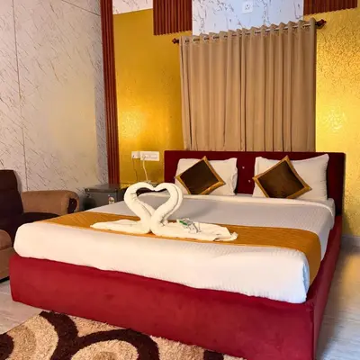 a bedroom with a bed with two swans on it at Unnati Luxury Homestay Coorg in Madikeri