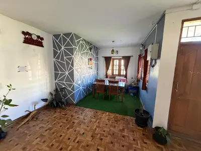 a living room with a table and a dining room at DM&sons guesthouse in Coonoor