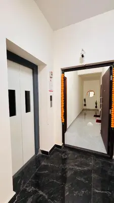 a hallway with an open door and a room at Ashley Homestay 2BHK Codissia, Airport, Tidel Park in Coimbatore