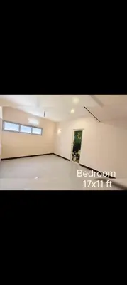 a large empty room with a painting on the wall at R N P Guest House in Pollāchi
