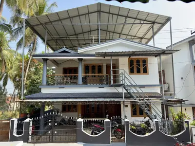 a house with a staircase in front of it at Sreekrishnapuram Family Retreat in Karimpuzha