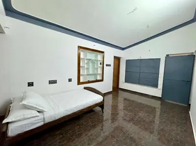 a bedroom with a bed with a blue ceiling at Sreekrishnapuram Family Retreat in Karimpuzha