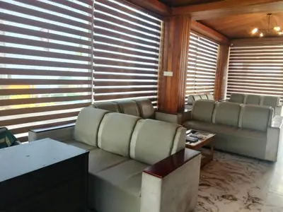 a living room with a couch and a table at TULIPS VILLAGE RESORTS - A Valley View Abode in Ooty