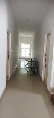 a empty hallway with two chairs in a room at K square in Coimbatore