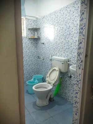 a bathroom with a toilet and a sink at K square in Coimbatore