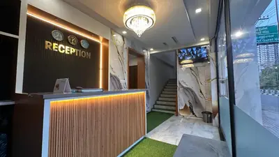 a lobby with a reception desk in a building at Ellora grand hotel in Kozhikode