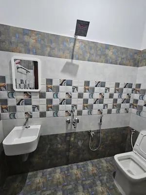 a bathroom with a sink and a toilet at Home in Pollachi in Pollāchi