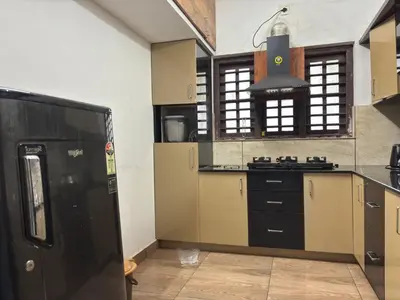 a kitchen with a stove and a stove top oven at Nilavu Homes Retreat in Wayanad