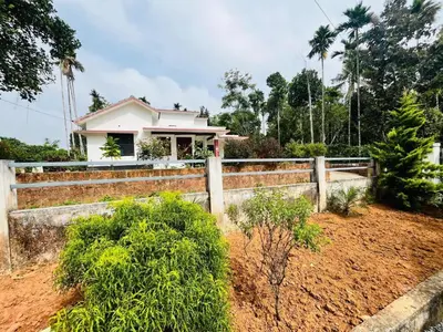 a house with a fence in front of it at Nilavu Homes Retreat in Wayanad