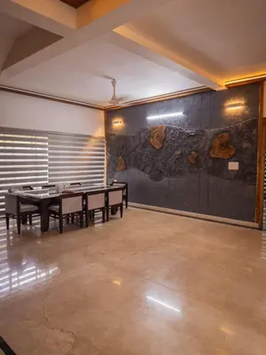 a room with ping pong tables and a wall at Akshaya Homestay in Trichūr