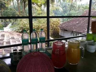 a group of bottles on a table in front of a window at 36 Palms Boutique Retreat in Cherai Beach