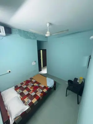 a bedroom with a bed and a ceiling at GK residency in Kozhikode