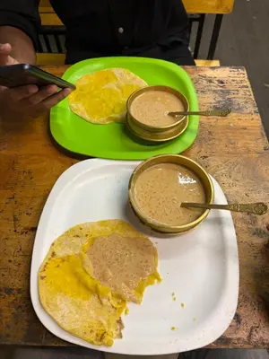 a table with a plate of food and a plate of pancakes at GK residency in Kozhikode