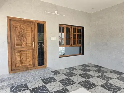 a room with a wooden door and a tiled floor at Eachanari Karpaga Rathinam Residency By Shivalaya Stays in Coimbatore