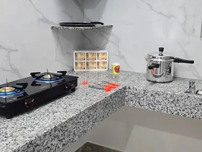 a stove top oven sitting on top of a counter at Eachanari Karpaga Rathinam Residency By Shivalaya Stays in Coimbatore