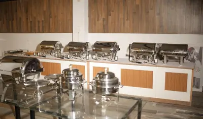 a kitchen with pots and pans on a counter at Bombe Resort Channapatna in Channapatna