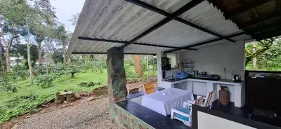 a kitchen with a view of a garden at Echupary Estate cottage in Gonikoppal