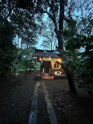 a small house in the middle of a forest at Echupary Estate cottage in Gonikoppal