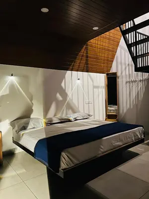 a large bed in a room with at Hill wood nature touch resort in Pinangode