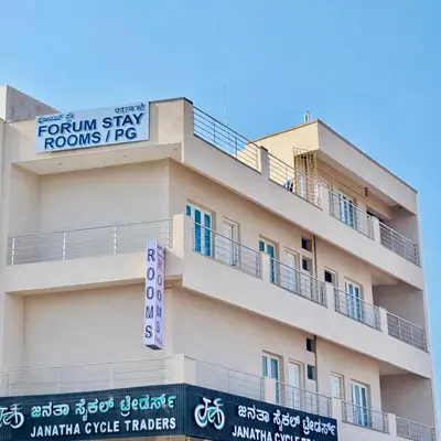 a building with a sign on top of it at Forum Stay in Mysore