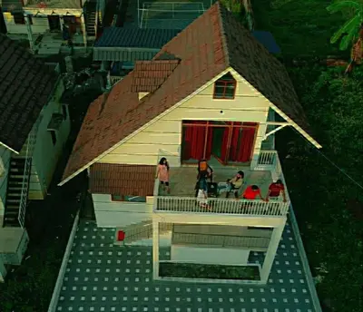 a group of people standing on the balcony of a house at The NEST VILLAS in Athirappilly