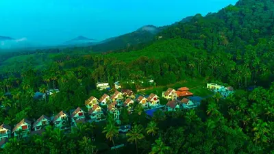 a group of houses in the middle of a mountain at The NEST VILLAS in Athirappilly