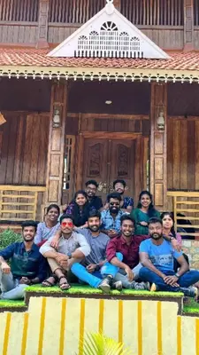 a group of people posing in front of a house at JackRoot Athirappilly in Kallana