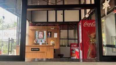 a store front with a cocacola store with a counter at Flavoury Restaurant & Rooms in Paithalmala