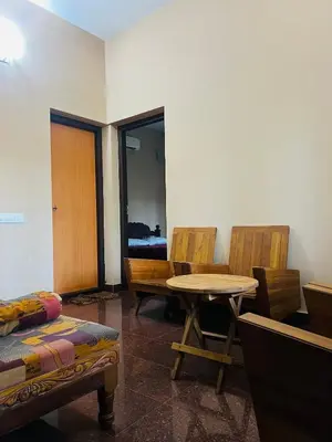 a room with chairs and a table and a table and chairs at Chirakkal Heritage Luxury Homestay in Manjeri