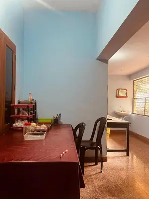 a living room with a wooden table and chairs at Chirakkal Heritage Luxury Homestay in Manjeri