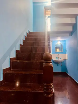 a staircase with a sink in a room with blue walls at Chirakkal Heritage Luxury Homestay in Manjeri