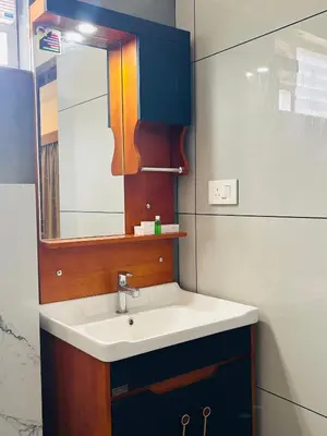 a bathroom with a sink and a mirror at FORTUNE BANASURA Resort in Kalpetta