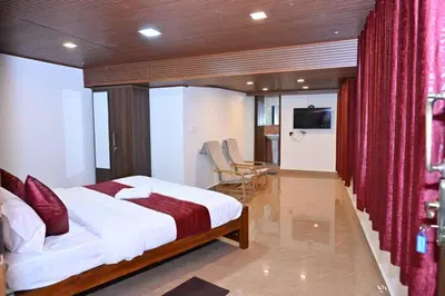 a bedroom with a large bed with a red curtain at Radisson in Madikeri