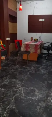 a room with a table and chairs in it at Hotel AB Merridien in Coimbatore