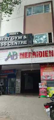 a building with a sign on the side of it at Hotel AB Merridien in Coimbatore