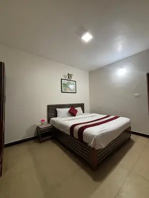 a bedroom with a large bed in a room at Blessing holidays ooty in Ooty