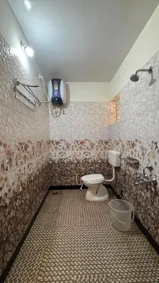 a bathroom with a toilet and a sink at Blessing holidays ooty in Ooty