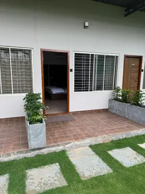 a house with two windows and a patio at Bhoomi in Mysore